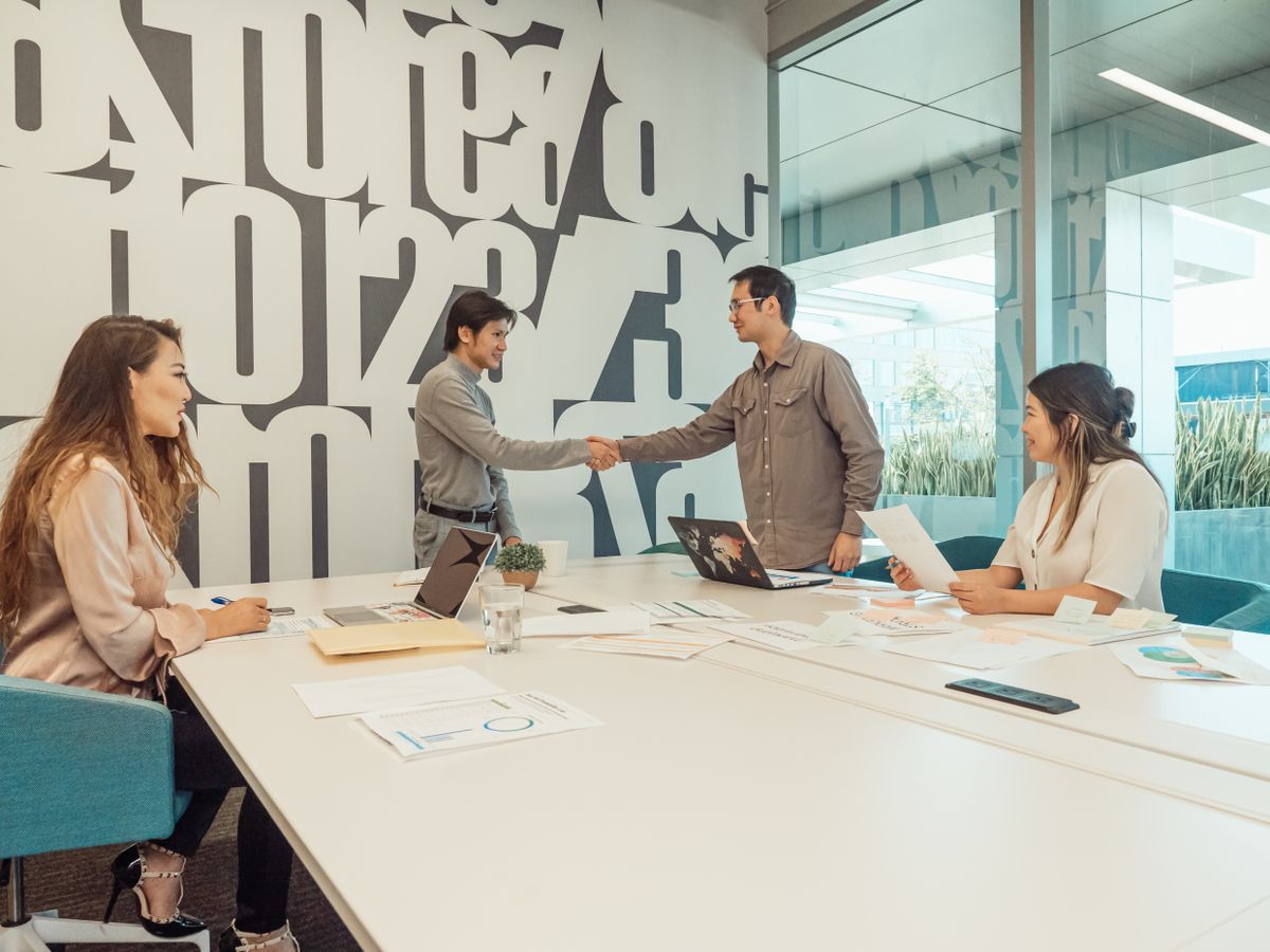 Illustrative photograph of colleagues collaborating around a table
